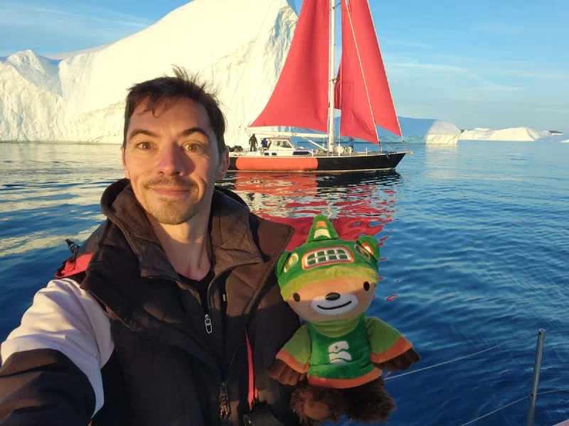 Sumi and Nicholas on a boat in Greenland with icebergs