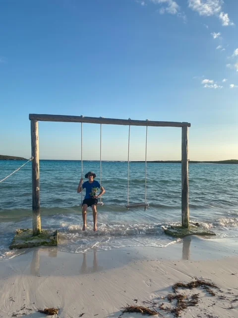 Sumi Bear on a swing in Abaco Club in the Bahamas