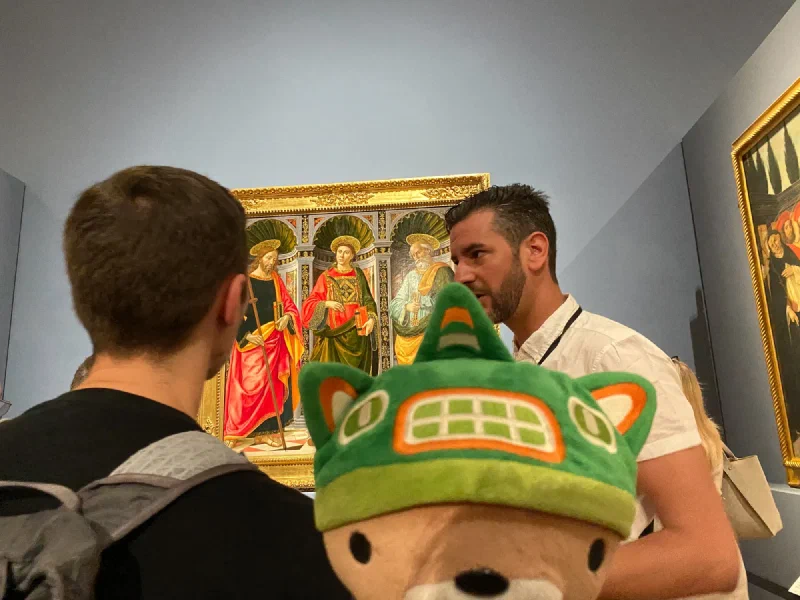 Guide explaining a painting in the gallery