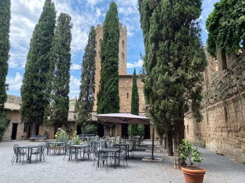 La Badia di Orvieto courtyard with cypress trees and tower
