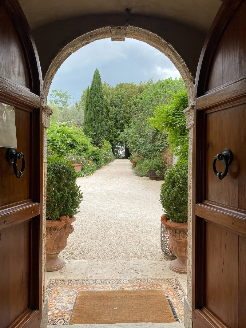Villa Cicolina entrance with stone arch and gravel drive