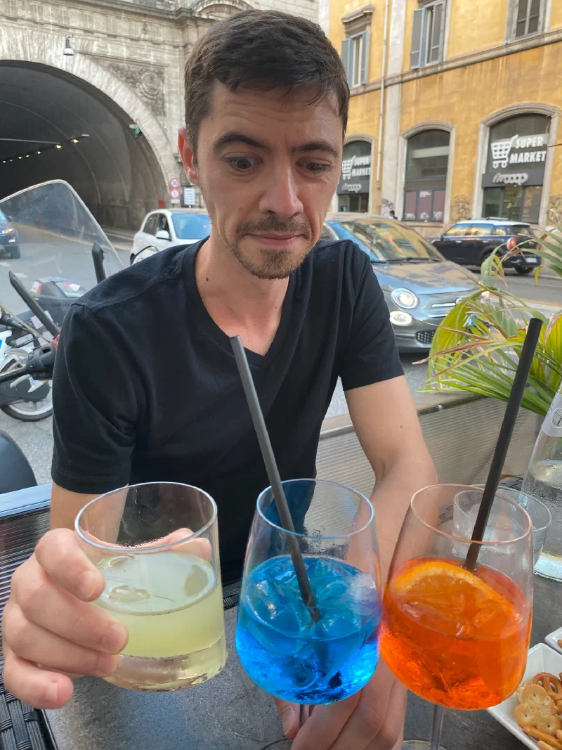 Colorful aperitivo drinks - limoncello, blue cocktail, and Aperol spritz