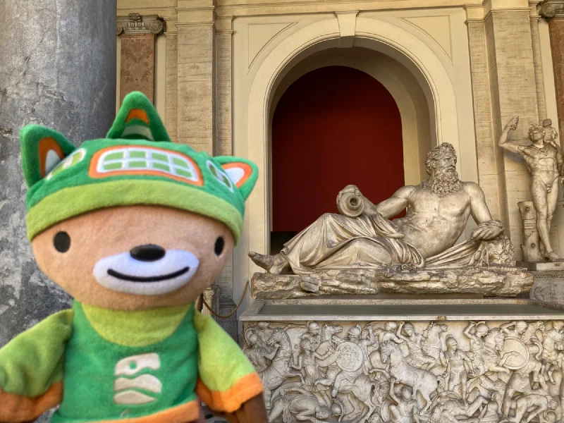 Sumi next to a classical river god sculpture