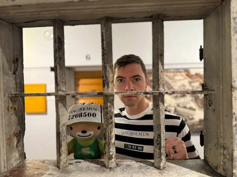 Nicholas and Sumi behind heavy barred opening