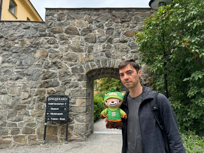 Nicholas holding Sumi at the stone entrance to Långholmen