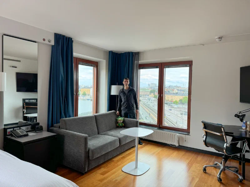 Nicholas and Sumi in a modern Stockholm hotel room with city view