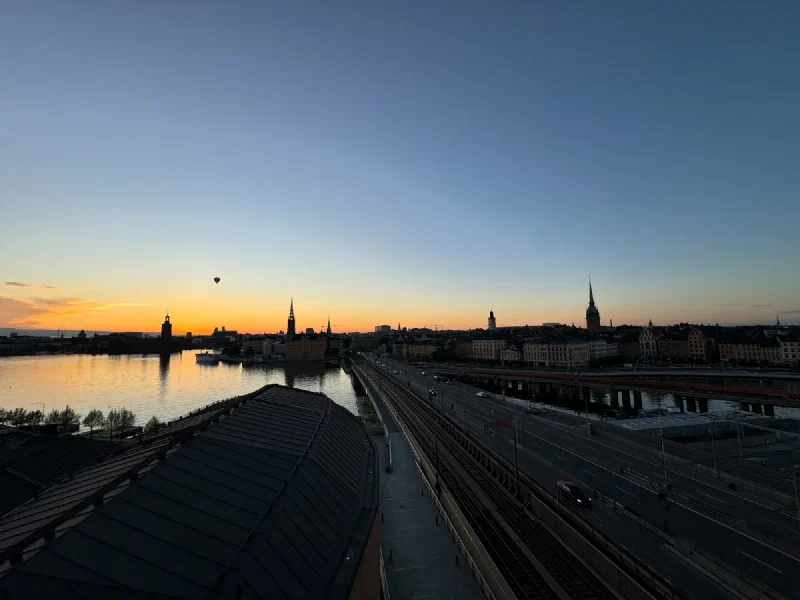 Stockholm sunset panorama with hot air balloon and church spires in silhouette