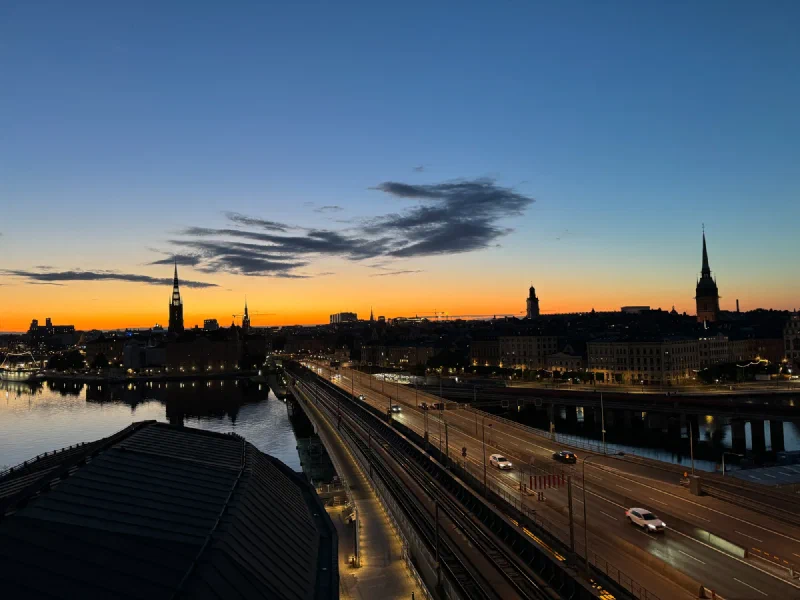 Stockholm at twilight with deep blue sky and bridge lit by car headlights