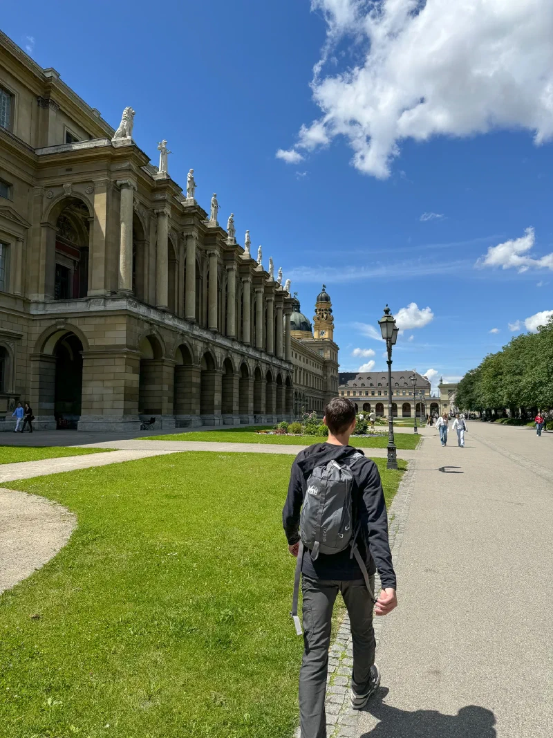 Nicholas walking beside the Residenz arcades in Munich
