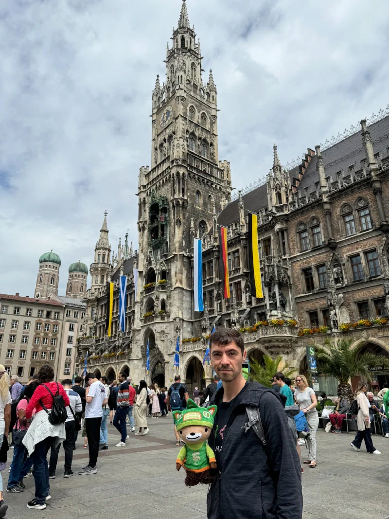Nicholas holding Sumi in Marienplatz with the Neues Rathaus behind
