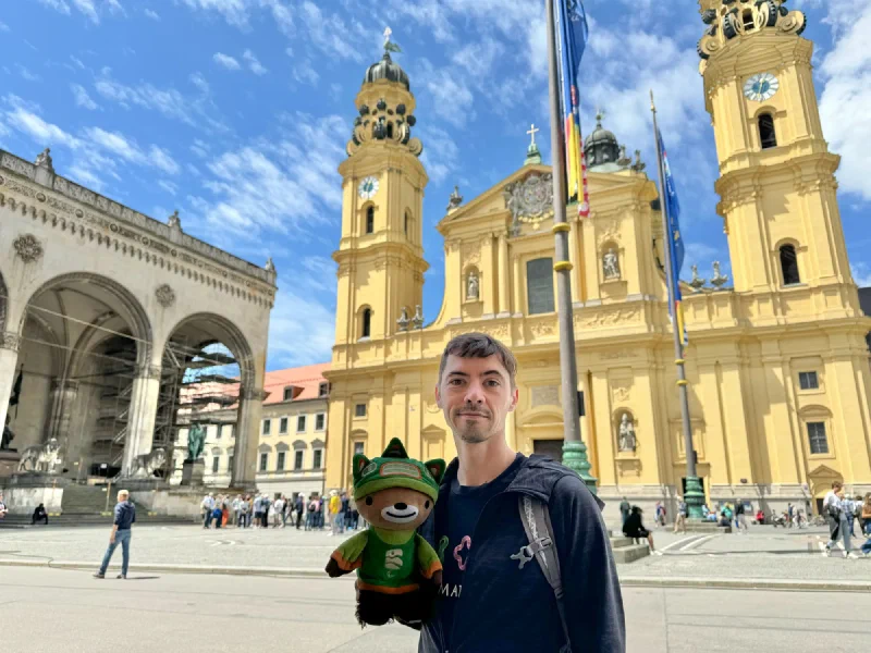 Nicholas holding Sumi in front of the yellow Theatine Church in Munich