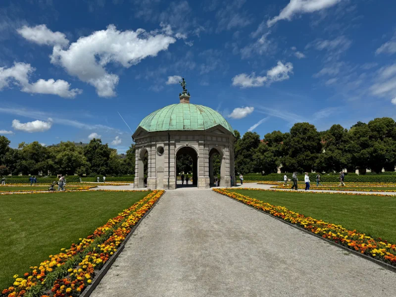 View down a formal garden path to the Dianatempel pavilion in Munich's Hofgarten