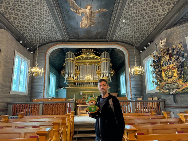 Nicholas and Sumi in the church nave with organ and chandeliers