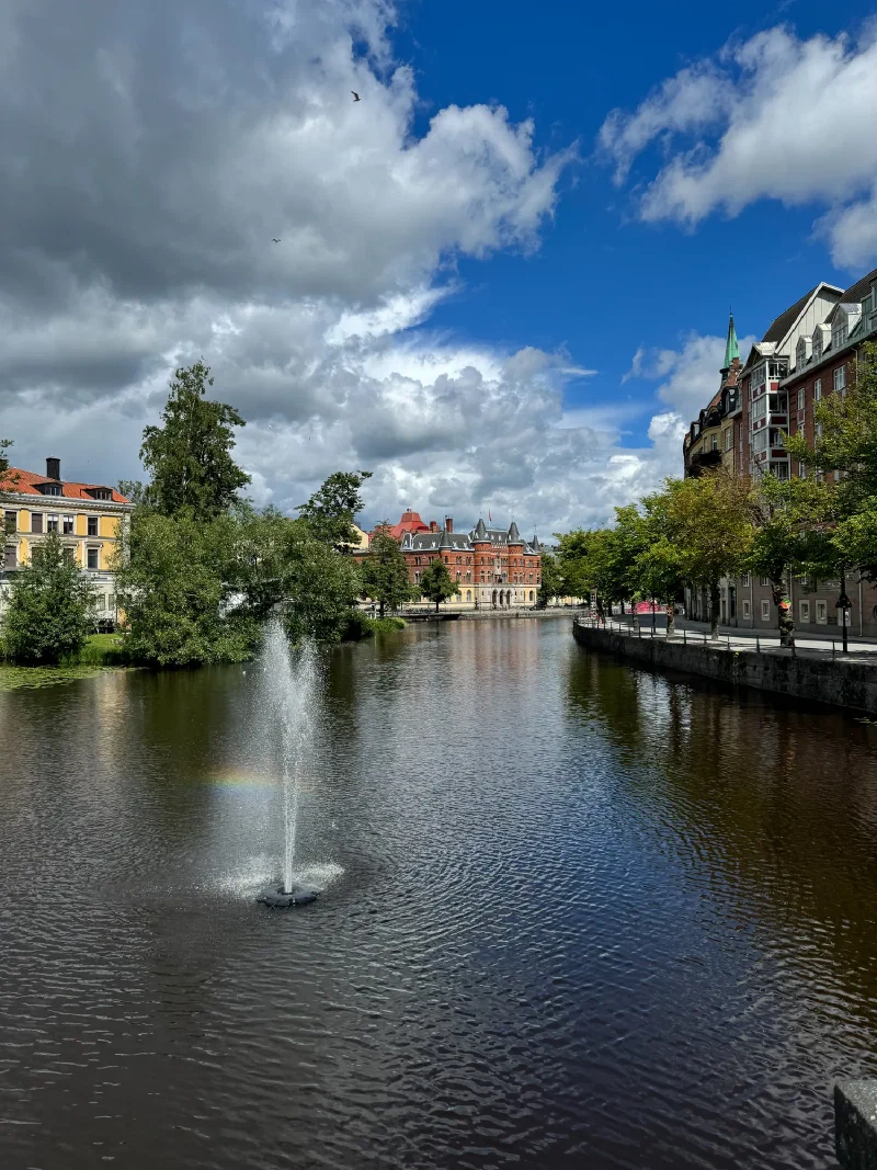 Storm clouds breaking over the river in Örebro with rainbow