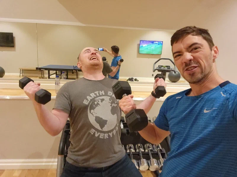 Nicholas and Adam posing with dumbbells in the hotel gym