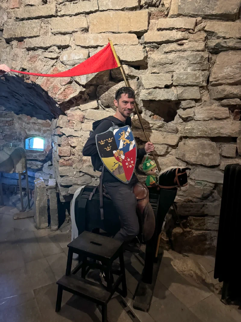 Nicholas on wooden toy horse with Sumi riding alongside