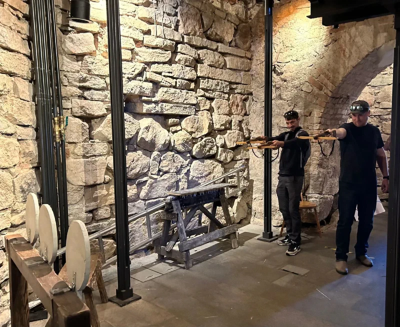 Nicholas and Adam firing wooden crossbows at targets