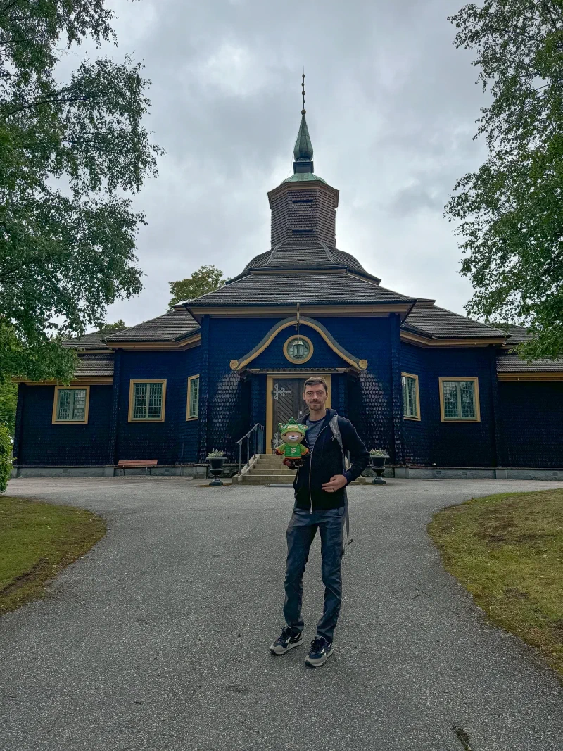 Nicholas holding Sumi in front of Ramundaboda church in Laxå
