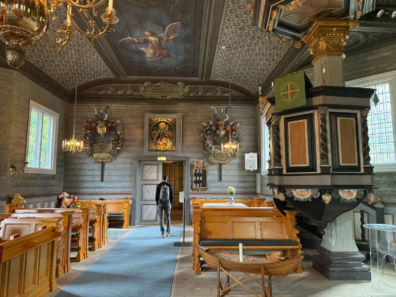 Church interior with painted ceiling, pulpit, and hymn board