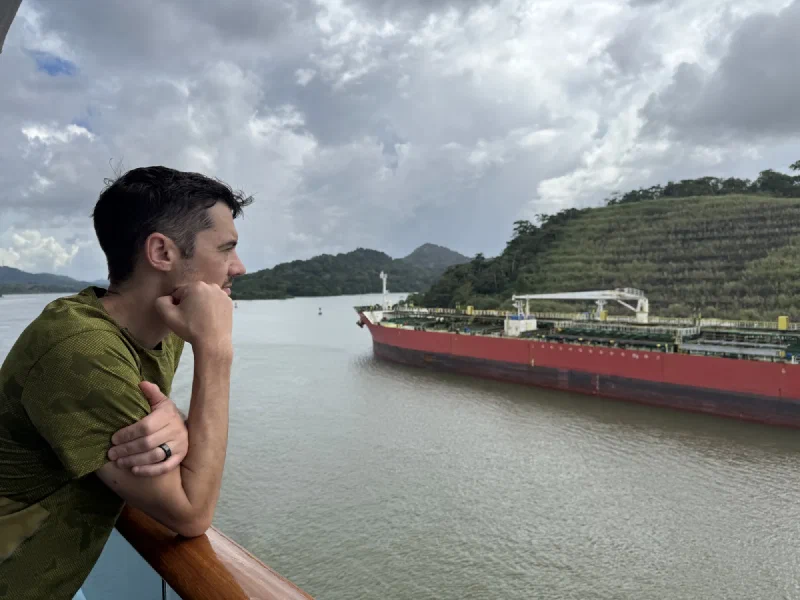 Red tanker in a narrow jungle-lined section