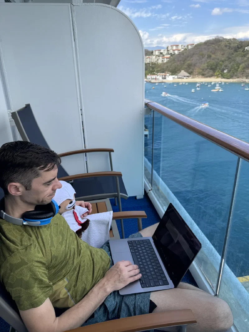 Nicholas working on laptop on the balcony with me