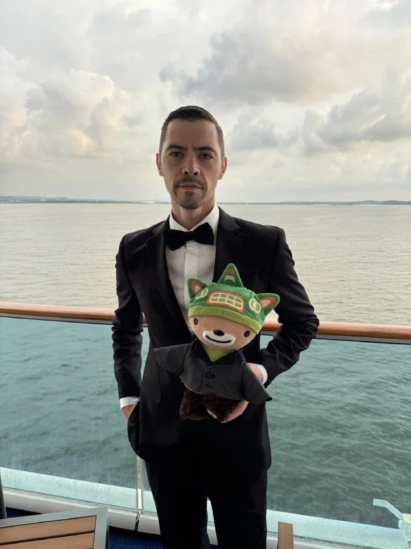 Nicholas in a tuxedo and me in my suit on the balcony