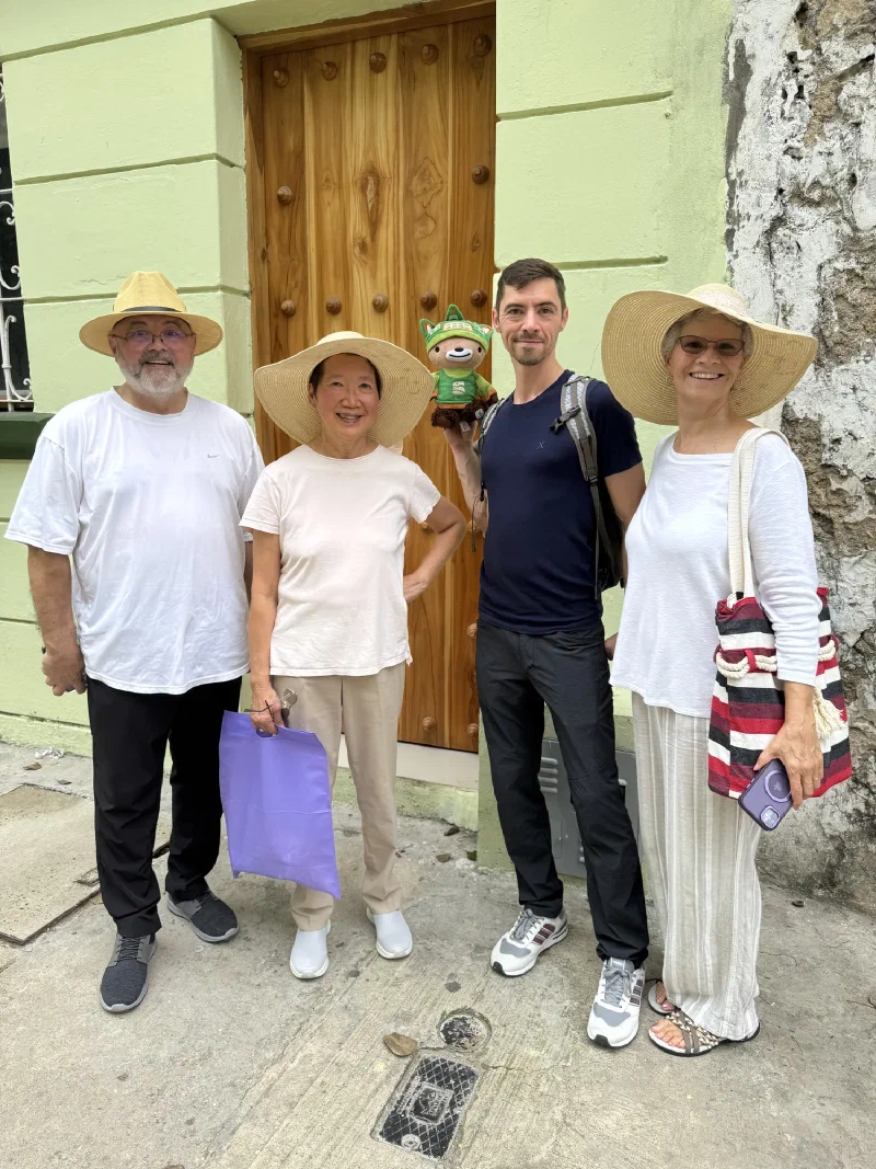 Group in front of a green colonial wall