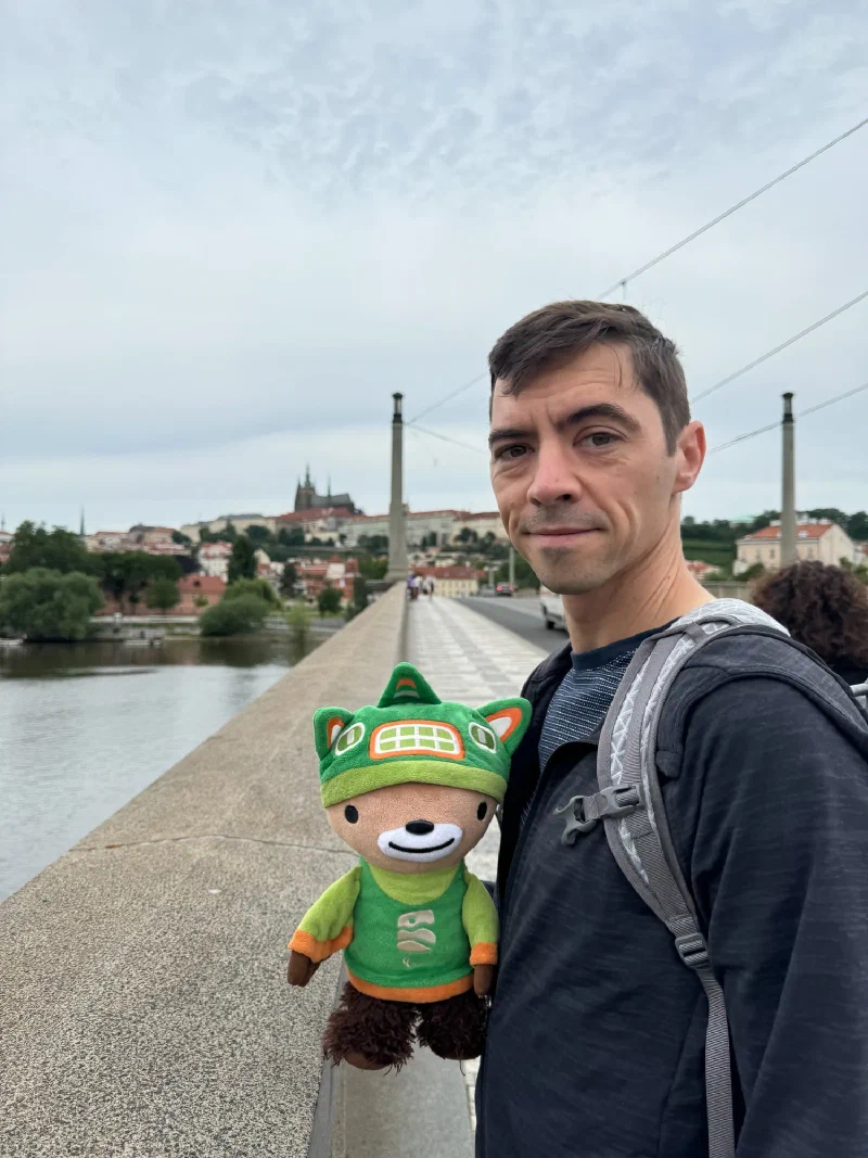 Nicholas and Sumi Bear on the bridge with the castle lit up