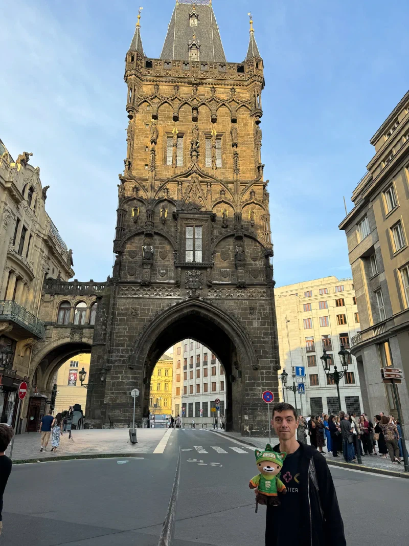 Nicholas holding Sumi Bear in front of the Powder Tower