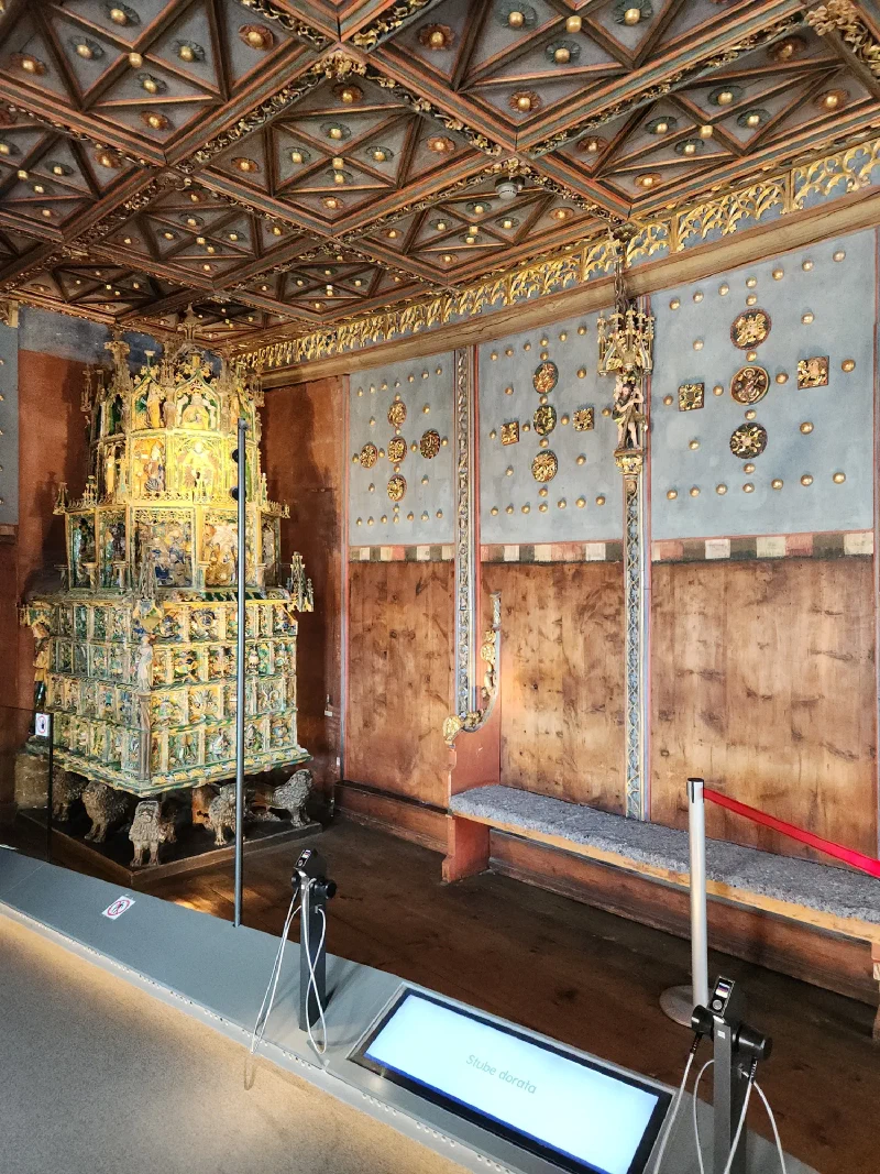The Golden Room with ornate Gothic tiled stove and gold-leafed ceiling