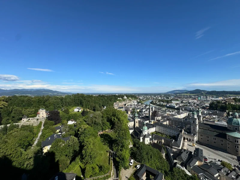 Panoramic view of Salzburg from Hohensalzburg Fortress showing cathedral dome, Salzach River, and old town