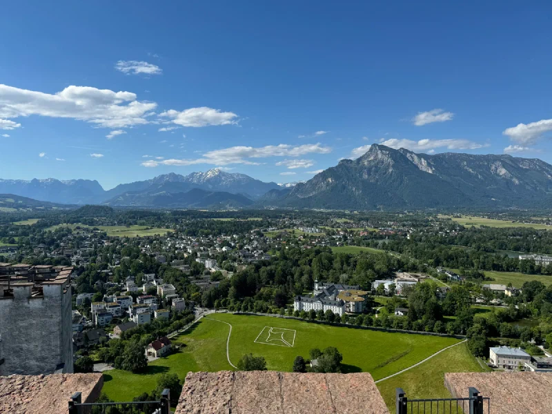 View from Hohensalzburg ramparts showing Untersberg and a tower with machicolations