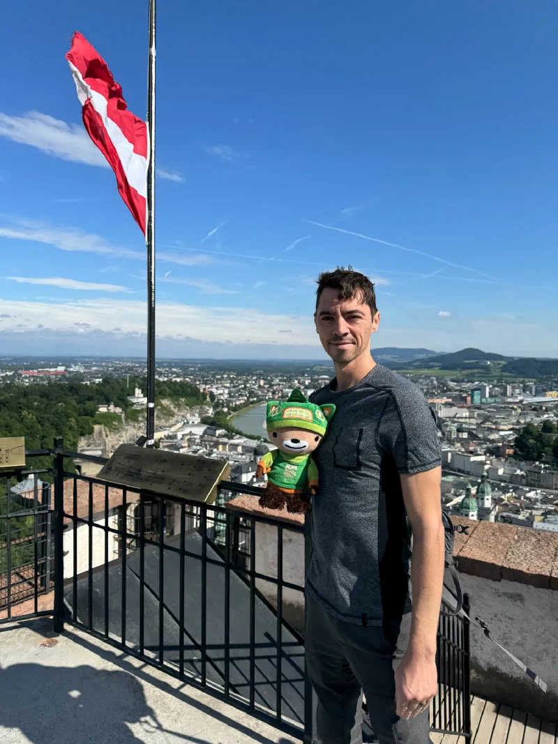 Panoramic view of Salzburg old town from fortress with Austrian flag and Sumi