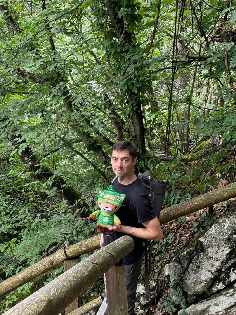 Nicholas with Sumi Bear on wooden stairs in the forest