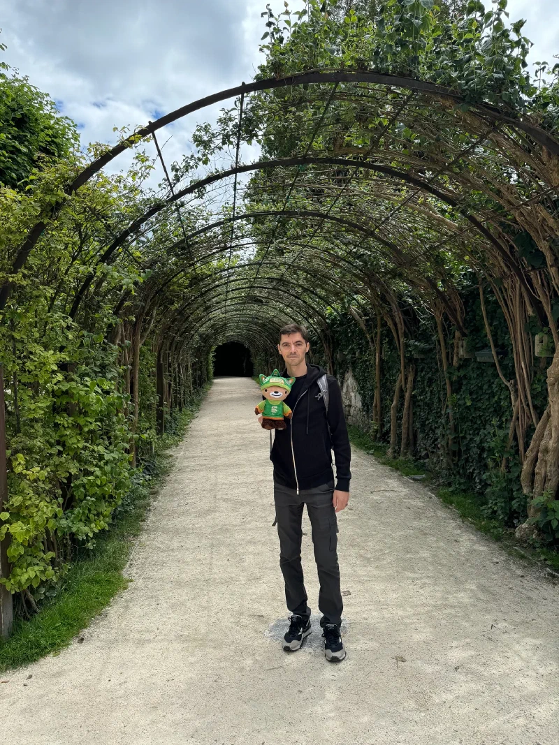 Nicholas and Sumi Bear under the vine-covered garden tunnel