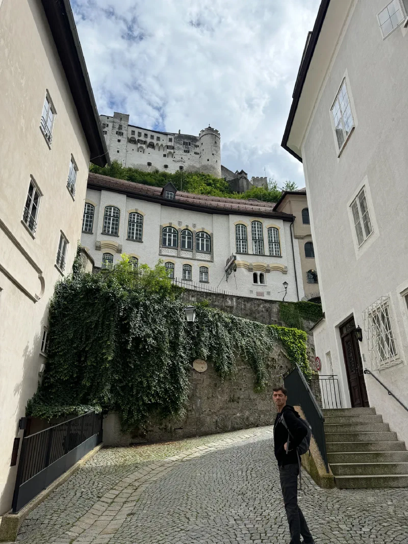 Nicholas on a cobblestone lane beneath the fortress