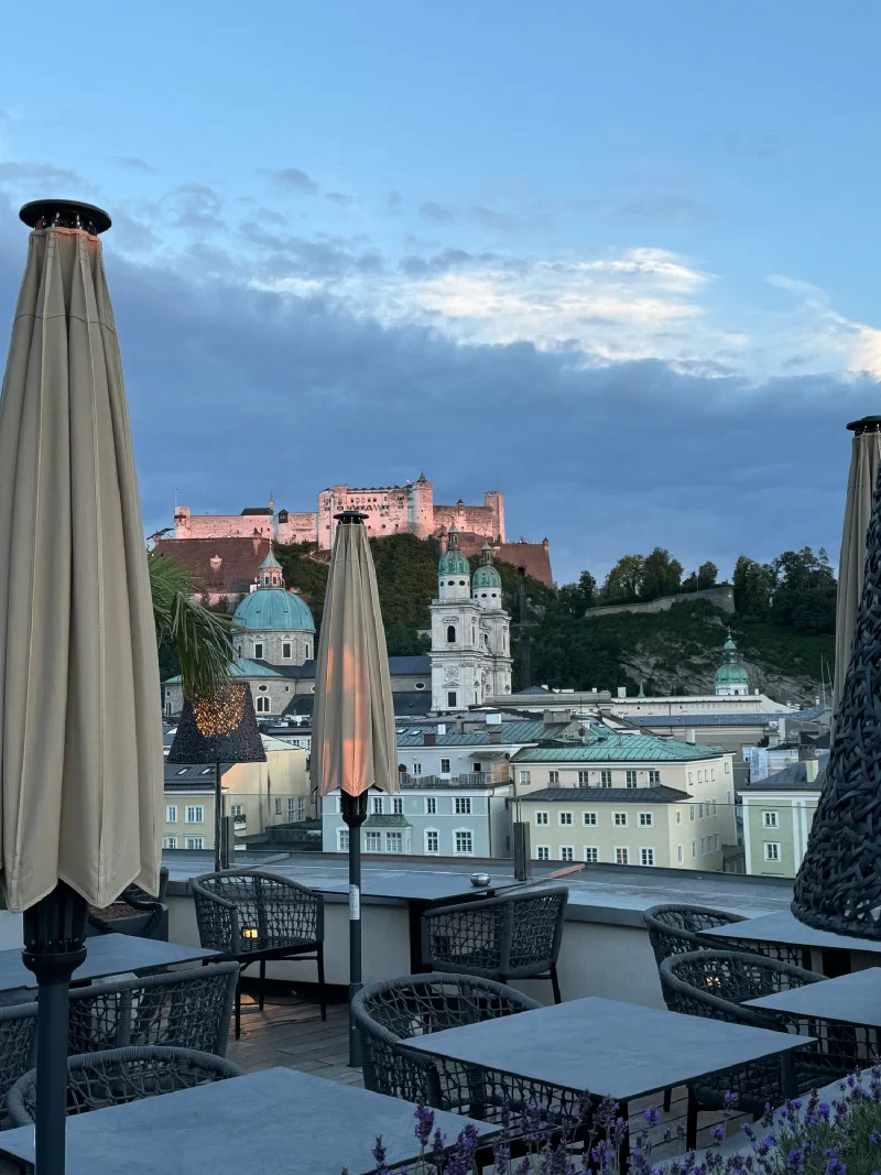 Rooftop terrace overlooking Salzburg at dusk