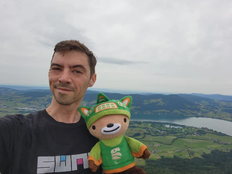 Summit selfie with Sumi and alpine panorama