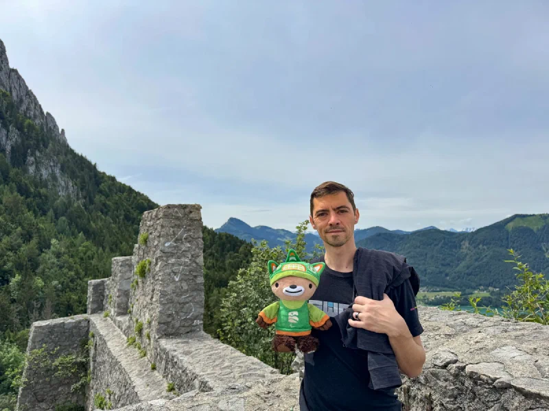 Nicholas with Sumi at the ruin parapet with mountain ridges behind