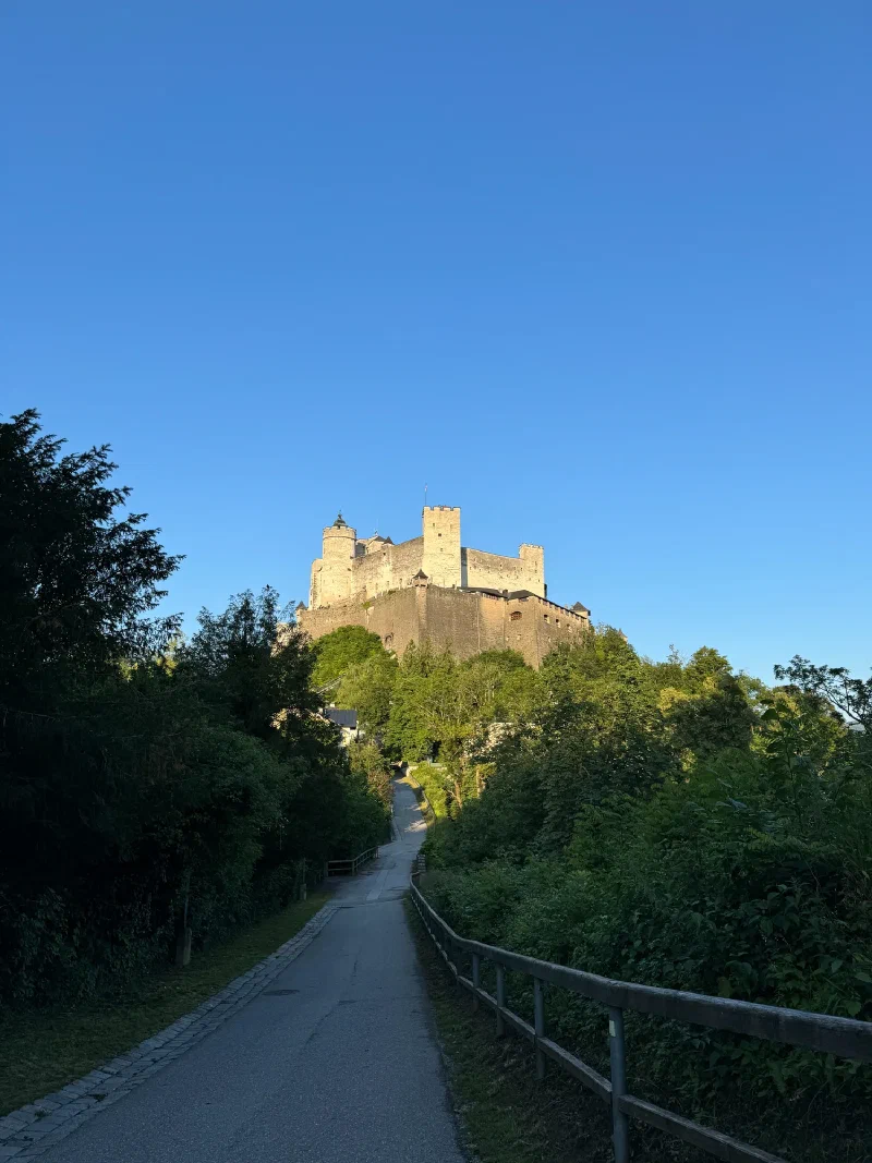 Path under the fortress walls in warm evening light