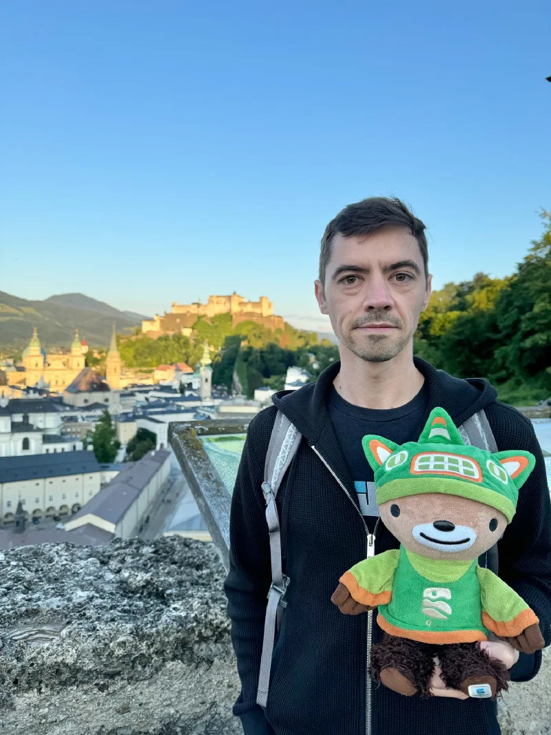 Nicholas holding Sumi at the overlook with fortress and old town behind