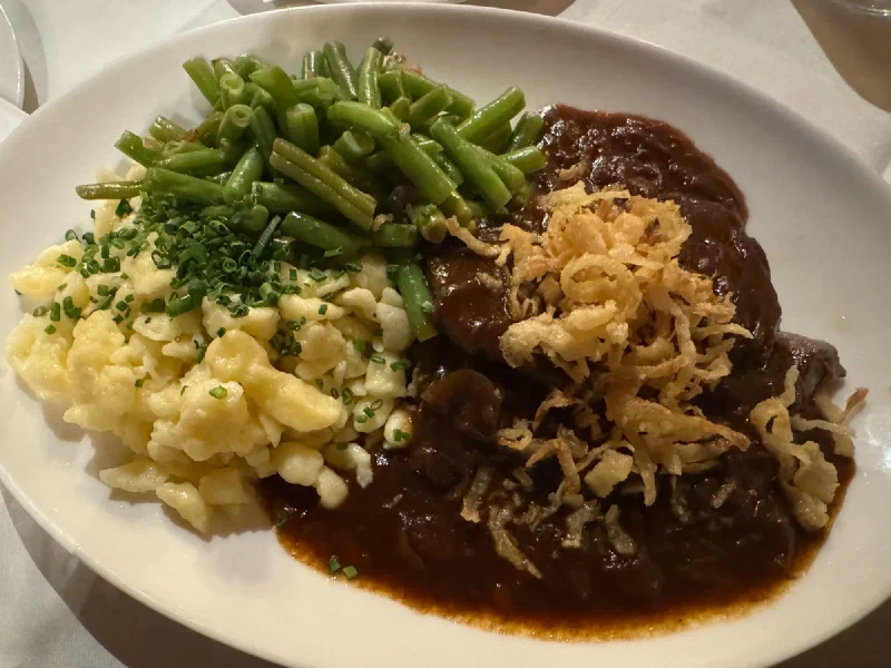 Austrian dinner plate with braised beef, spätzle, and green beans