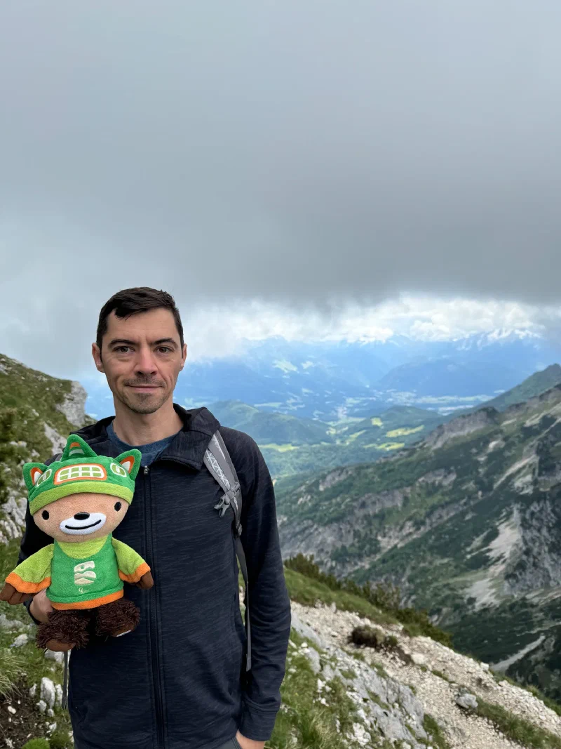 Nicholas holding Sumi with dramatic cloud ceiling overhead