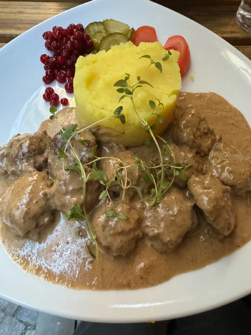 Classic Swedish meatballs with mashed potatoes, lingonberries, and pickles