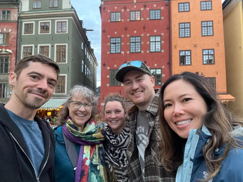 Family selfie in front of colorful Gamla Stan buildings