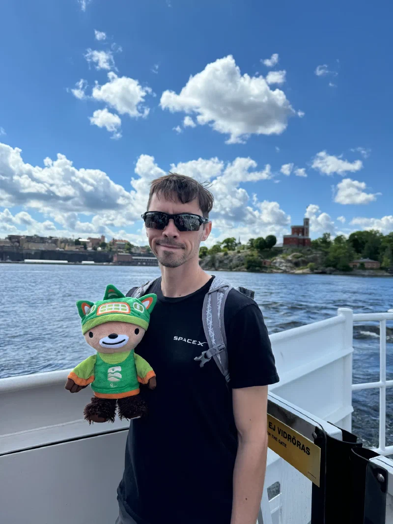 Nicholas and Sumi on ferry deck with island in background