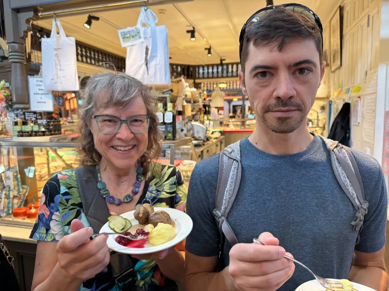 Nicholas and his mom tasting Swedish meatballs at the food hall