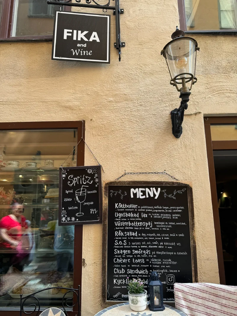 Charming Stockholm café exterior with FIKA and Wine sign