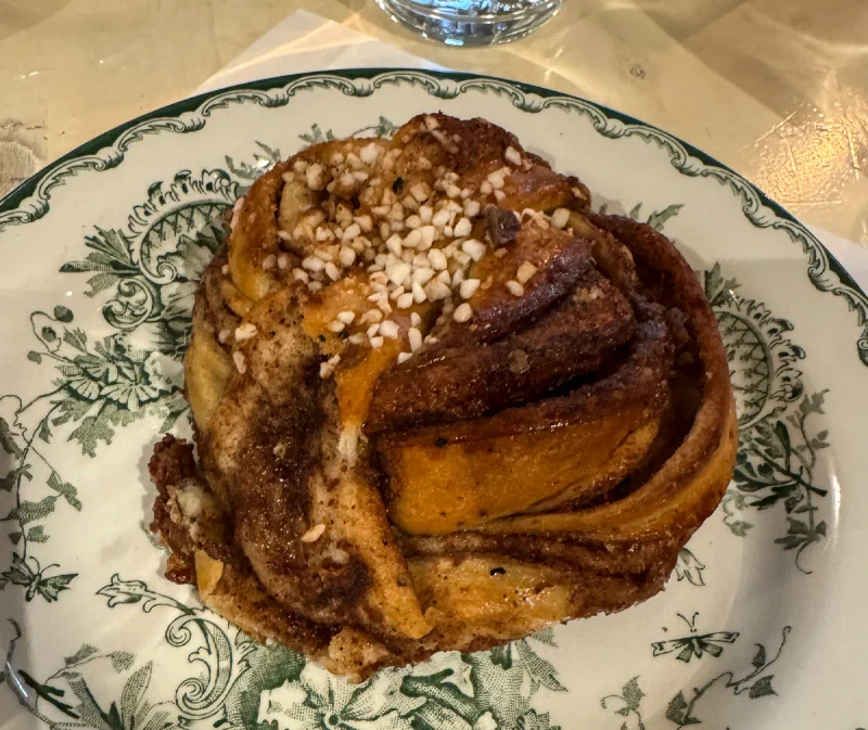 Swedish cinnamon bun on ornate floral plate