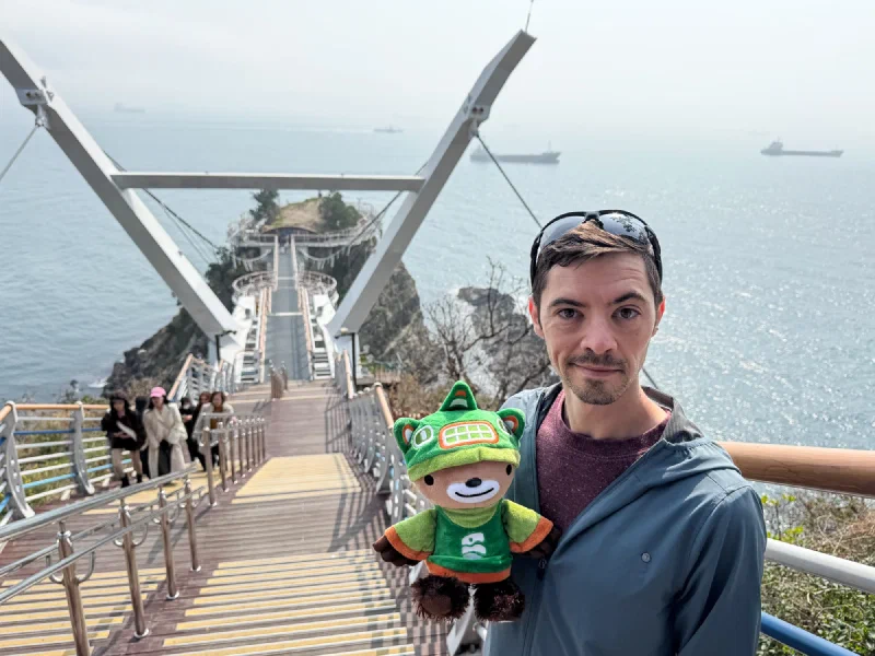 Sumi on a coastal skywalk extending over the ocean